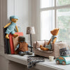Maileg Toy bears and a car on a windowsill with a lamp and books in the background